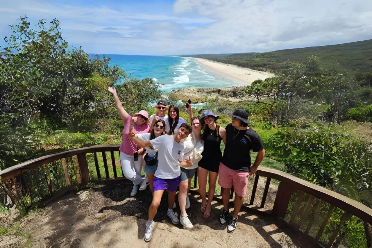 Group of travellers at North Gorge Walk with North Stradbroke Island beach backdrop