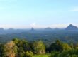 Scenic view of the Glass House Mountains on the Sunshine Coast Queensland with lush forest and clear blue sky