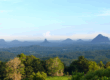 Scenic view of the Glass House Mountains on the Sunshine Coast Queensland with lush forest and clear blue sky
