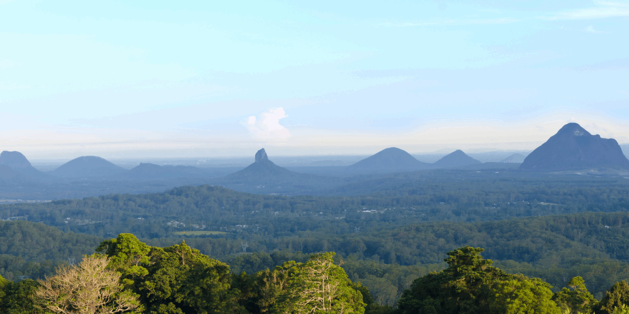Glass House Mountains Scenic View, Sunshine Coast Queensland Scenic view of the Glass House Mountains on the Sunshine Coast Queensland with lush forest and clear blue sky