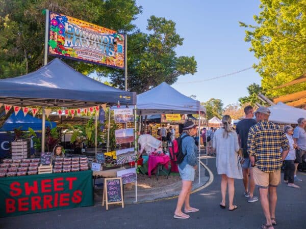 Visitors browsing stalls at Eumundi Markets on the Sunshine Coast